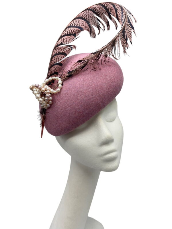Pink felt headpiece with feathered detail.